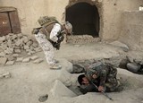 FILE — In this Saturday, Oct. 31, 2009 file photo, a member of U.S. special operations forces and an Afghan National Army soldier search for roadside bombs during a joint patrol in Shewan, a former Taliban stronghold in Afghanistan's Farah province. . President Hamid Karzai's office said Sunday, April 22, 2012 that Afghan and U.S. officials have finalized a long-awaited strategic partnership deal. The statement from the presidency says officials from both sides have initialed the document and it is now ready to be signed by the two presidents. The document was initialed Sunday by Afghan National Security Adviser Rangin Dadfar Spanta and U.S. Ambassador Ryan Crocker. (AP Photo/Maya Alleruzzo, File)