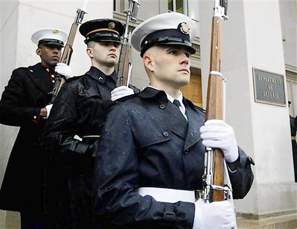 A United States military honor guard stands by their post in front of the Pentagon in Washington